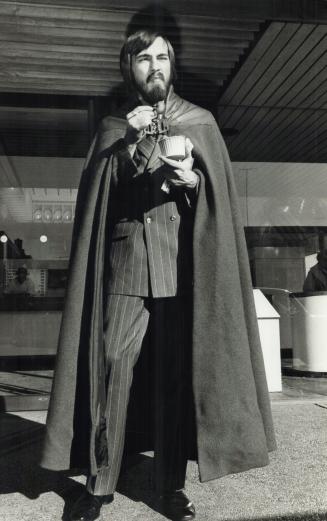 Poet-Journalist Douglas Fetherling, here with cape and favorite suit, is described by a friend as the best-dressed hippie he knows