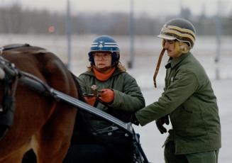 Groom Tom Avery helps an expectant Susan Fish straighten out the lines, left, before she drives solo for the first time, above, behind 4-year- old Citizen Cohen at Orangeville Raceway