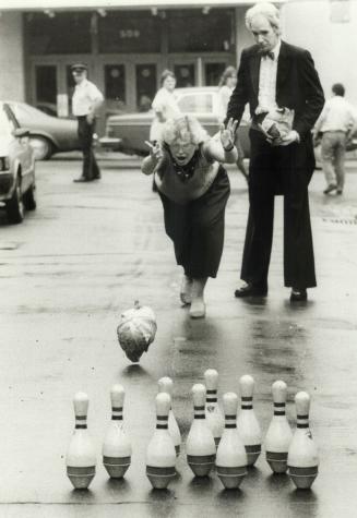 Cabbage fever: St. George MPP Susan Fish bowls a cabbage on Aberdeen St. at Parliament St. as Ed Street looks on. Cabbagetown's 10th annual festival will be held tomorrow
