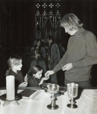 A Child feels at home in Holy Trinity Church in downtown Toronto where Rev
