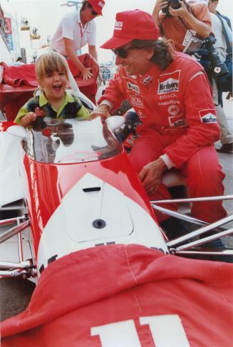 Joanna Fittipaldi, 3,giggles with glee aftr her father, Emerson Fittipaldi, 43, set a second Molson Indy record of 59