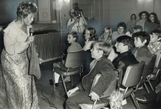 Ella Fitzgerald steps down from the stage to meet the wide-eyed children in her audience