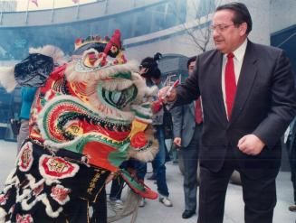 Colorful launch of airline. Metro Chairman Dennis Flynn dots the lion's nose (a sign of respect) as members of the Moh Dong Kung Fu Club perform tradi(...)