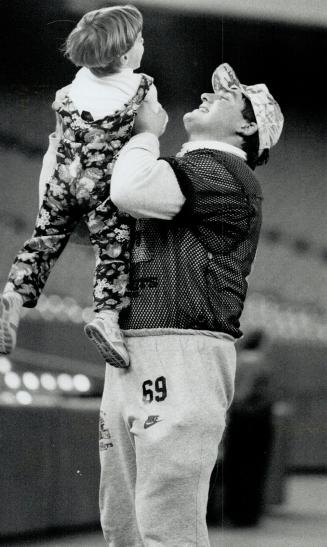 Light moment: Offensive guard Dan Ferrone gives it the tender touch with daughter Danielle, but by tomorrow his hands will be full of much bigger people