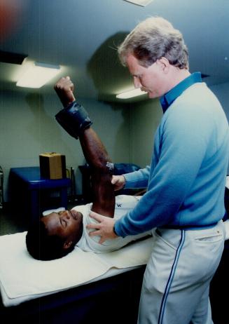 The unofficial Minister of Arms in the Blue Jays clubhouse is head trainer Tommy Criag, here helping Tony Fernandez strengthen his elbow