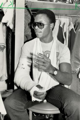Broken elbow: Shortstop Tony Fernandez sporting a large cast on his right arm, talks with teammates in the clubhouse last night