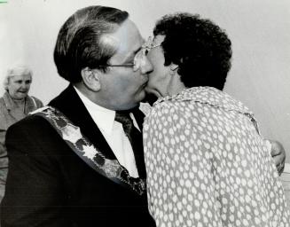 Victory kiss: Dennis Flynn's wife Margaret congratulates him with a kiss after the mayor of Etobicoke was elected new Metro chairman in a dramatic first-ballot vote at Metro council yesterday