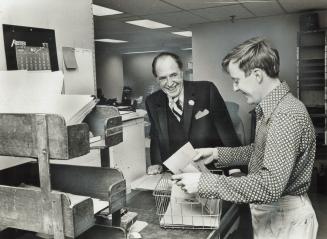 Harry Red Foster chats with mail clerk Bob Turkington