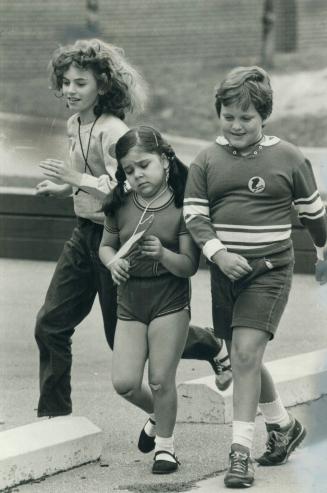 Tuckered out. It was a struggle, but 7-year-old Sandra Carrolio (middle) managed to finish the 10 laps around the block at Kensington Community Colleg(...)