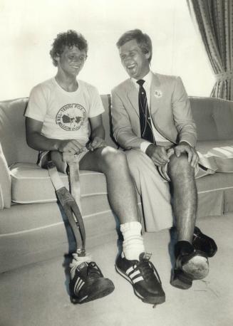 How's yours? One-legged runner Terry Fox and former hockey great Bobbu Orr check out their knees during Fox's second visit to with $25,000 cheque for Cancer research