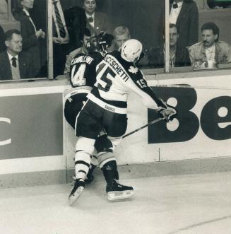 Lou at work: The Leafs' Lou Franceschetti makes his presence felt in a tussle along the boards with the Blues' Paul Cavallini during first-period action at the Gardens