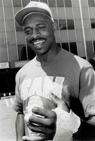 Give him a hand: Argo QB Rickey Foggie, who broke a bone in a finger in Thursday's loss to Hamilton, smiles after having a cast placed on his left hand