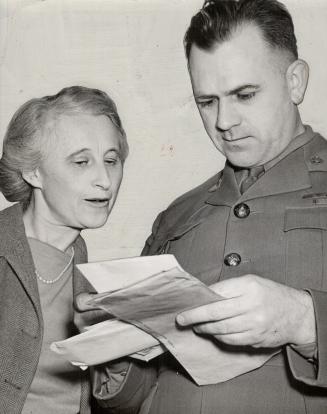 With his wife, the heroic minister reads letters and wires of congratulations from all over Canada
