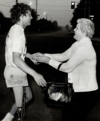 Hi, mom! One-legged runner Terry Fox is greeted by his mother, Betty, in a surprise reunion on Highway 2 near Whitby