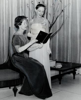 Looking over the menu at party last night sponsored by National Ballet Guild at Seaway Towers hotel are Mrs