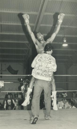The look of a winner: Dewith Frazer raises his arms in triumph as one of his cornermen hoists him high after he had scored an eighth-round TKO last night over veteran Pete Seward