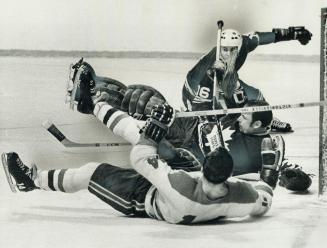 Goalie Bruce Gamble winds up in tangled heap with Claude Provost of Montreal, whom he has just robbed on a clear-cut breakaway, and Toronto teammate M(...)