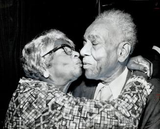 Harry Gairey gets hug from old friend Agatha King at testimonial dinner at which he was presented with Order of Distinction by Jamaican High Commissio(...)