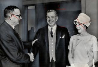 New Chief Justice takes over. Retiring Chief Justice J.C. McRuer (left) congratulates his successor, George Alexander Gale and Mrs. Gale, following Mr(...)