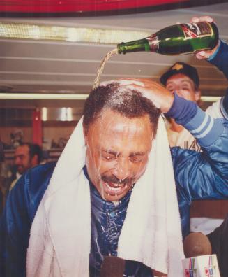 He's all wet: The bubbly and beer was flying in the clubhouse as manager Cito Gaston gets a thorough drenching