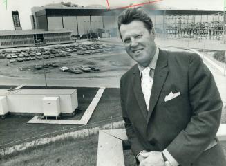 George Gathercole, chairman of Ontario Hydro, stands outside the atomic generating station in Pickering