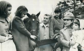 With one of the Gayford horses is rider Tom Gayford, centre, with his family