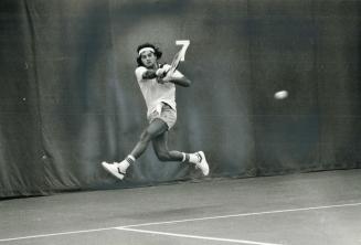 Rejean Genois is airborne as he returns a forehand on his way to Canadian indoor tennis final