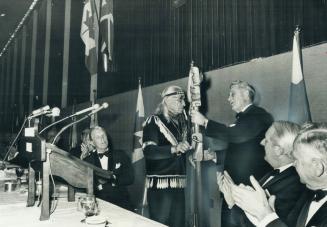 Indian actor Chief Dan George, 72, is presented with a totem pole by Richard Jones, president of the Canadian Council of Christians and Jews, at a cou(...)
