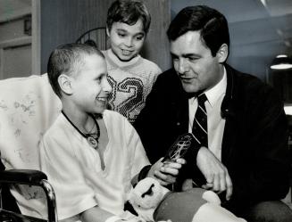Out-of-this-world autograph. Marc Garneau, Canada's first man in space, visits with patients at the Hospital for Sick Children yesterday. Claudio Ferr(...)