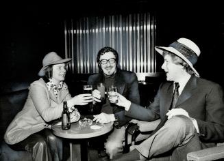 Having a drink before taking off for Australia, actress Pat Galloway, director Jean Gascon and actor Nicholas Pennell chat at malton airport yesterday(...)