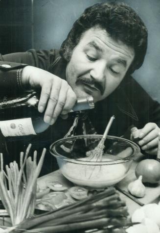 Bruno Gerussi adds just the right amount of brandy to his omelet, which he usually serves after theatre outing