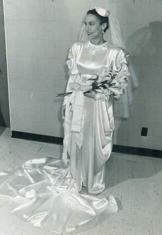 Mrs. Phil Givens wore the dress in which she married the mayor. It was designed by her father