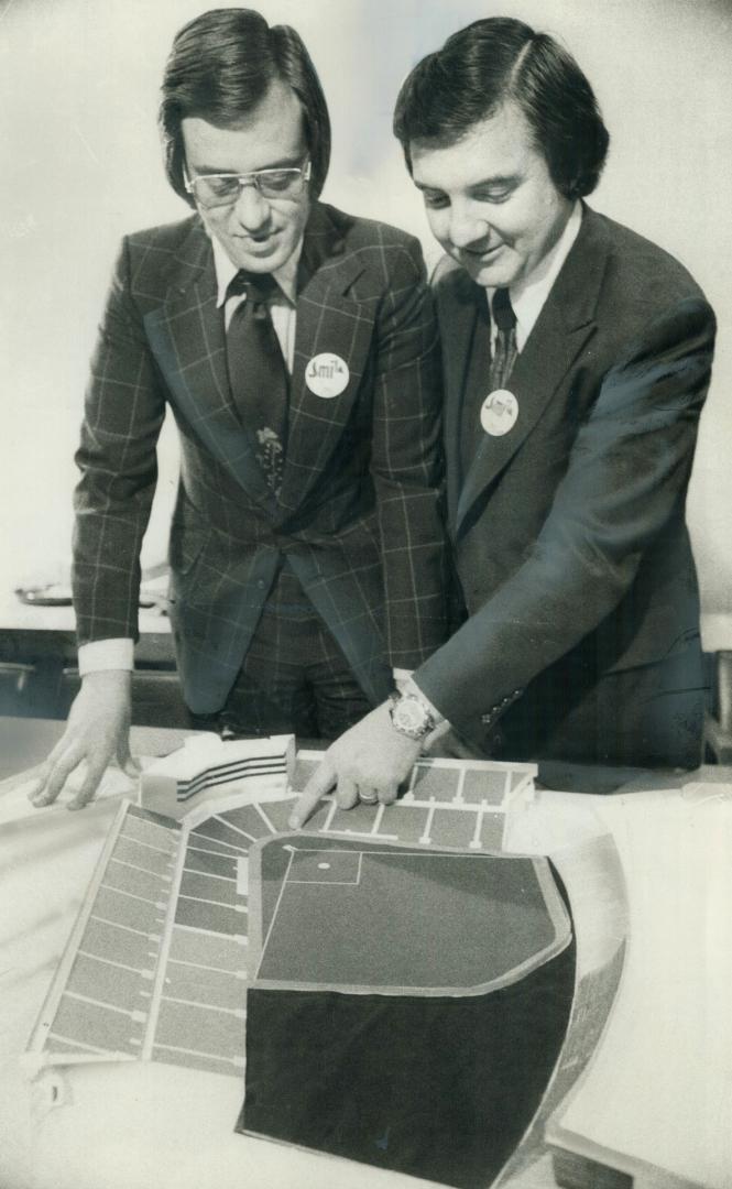Metro chairman Paul Godfrey, left, and Labatt's president Donald McDougall look over model of new home of the proposed Toronto Giants. Reader, below, (...)