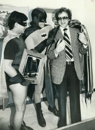 Caped crusader? Metro Chairman Paul Godfrey tries on his new cape, a gift from Gotham city and its dynamic duo