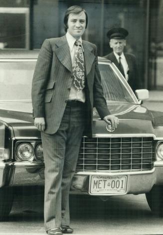 Metro's new acting Chairman Paul Godfrey stands outside official limousine at City Hall yesterday with chauffeur, Gord Frankland. Godfrey conducted hi(...)
