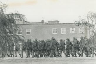 Troops poured into Montreal to guard public buildings shortly before police raids began last Friday under the War Measures Act invoked by Primer Minister Trudeau, who has vowed to smash FLQ