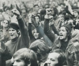 Clenched fists upraised a group of Montreal students chant FLQ slogans at the Paul Sauve Sports Arena in Montreal last night. About 2,000 turned out f(...)