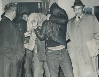 Leaving court after their remands are (heads covered), left to right, Kenneth Louis Amiotte, 22, of Byng Ave