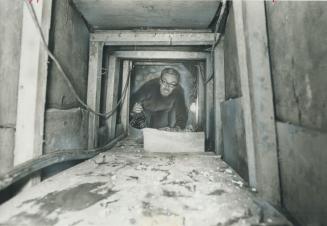 Star reporter Robert McKenzie crawls into the 25-foot-long tunnel under a secluded farmhouse near St