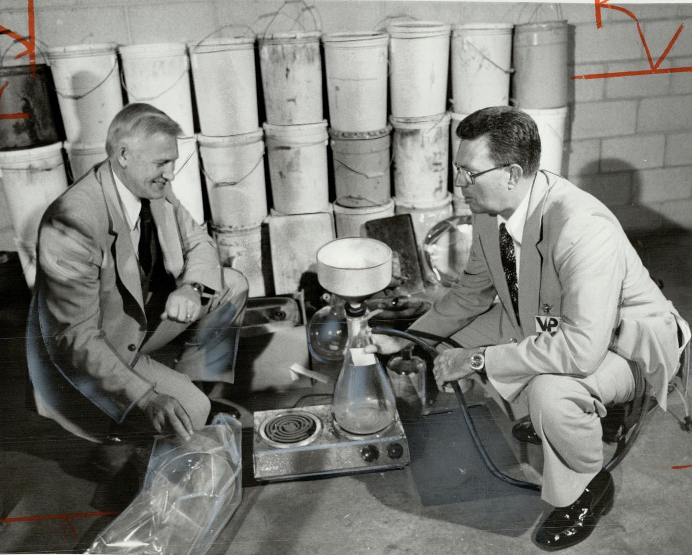 Speed lab: Inspector Sefrin Ginther of the RCMP, left, and Inspector Forbes Ewing of Metro police look over equipment seized in a drug lab near Penetanguishene this week
