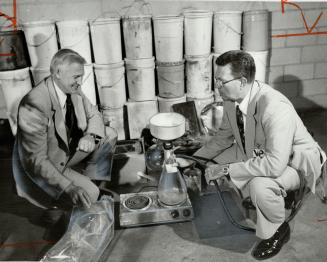 Speed lab: Inspector Sefrin Ginther of the RCMP, left, and Inspector Forbes Ewing of Metro police look over equipment seized in a drug lab near Penetanguishene this week