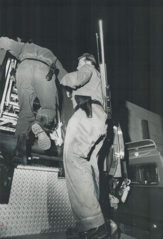 Armed police sharpshooters mount an aerial ladder above the hostage drama