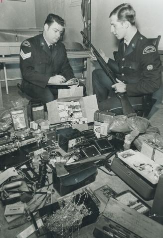 Loot from Robberies in Markham, returned to police headquarters by four juveniles who were caught after a three-month crime spree, is checked by Sgt. (...)