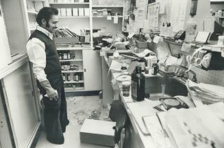 Hari Kambo surveys the damage done by thieves who broke into the drugstore and caused $25,000 damage