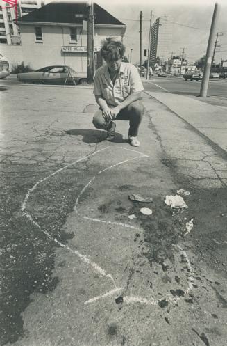 Brian McMillan, 17, foster brother of Dan Gregor, one of three youths shot down in North York shopping plaza, studies police chalk marks showing howon(...)