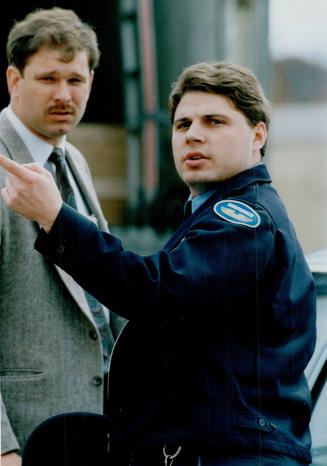 Daring holdup: An unidentified Brink's employee speaks with a detective after Yorkdale's second Brink's holdup in less than two years