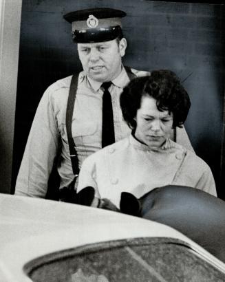 Constable Arthur Weidmark leaves Toronto East General Hospital with his wife Pat after receiving treatment for a graze wound in his left shoulder