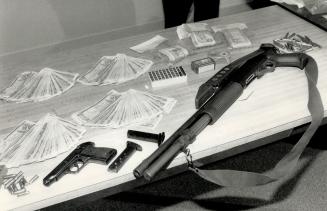 Gold theft triggers drug bust, OPP Superintendent Wib Craig looks over evidence seized in weekend raids - loaded guns, cash and six pounds of cocaine (...)