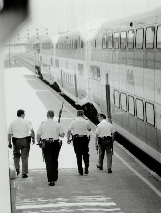 To catch a thief, Metro police search railway tracks between Union Station and the SkyDome for an armed man who robbed a bank at 88 University Ave. an(...)