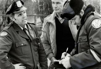 Victim and hero: Metro Police officer Mike Jenkins talks to an unidentified Brink's driver slugged by youthful holdup man